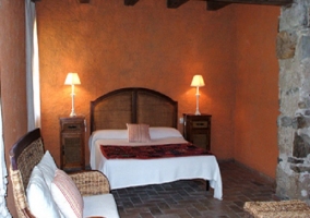  Two single beds in a room with stone walls 