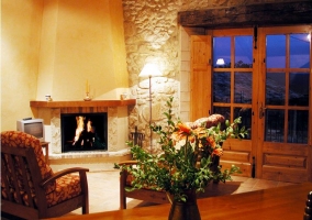  Living room with armchairs and table and kitchen 