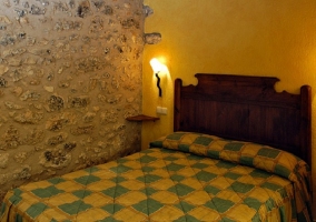  Bed in room with white and blue bedspread 