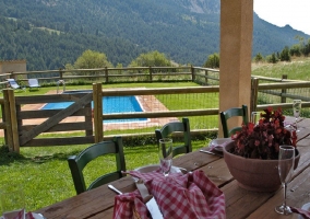  Dining table on the terrace with pool in the background 