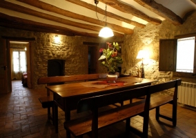  Stone living room with exposed beams and fireplace 