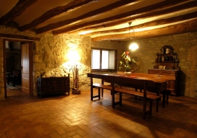  Dining room with stone walls and exposed beams 