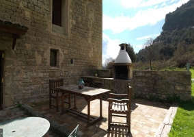 Barbecue in the garden with wooden table 