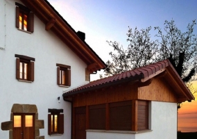  Main facade of the house, with wooden doors and windows 