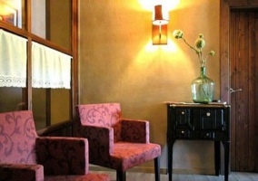  Living room with armchairs supported on the stone wall 