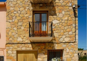 Access to the three-storey house with stone facade 