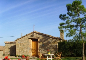 Main access to the house with wooden table and chairs 