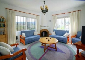  Living room with blue armchairs and TV 