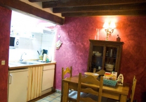  Kitchen and dining room with wooden table and cupboard 