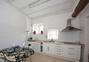  White dining room with windows in the stone wall 