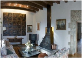  Living room of the rural house with fireplace, TV and wooden ceilings 