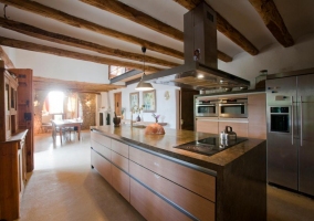  Dining room of the house with the kitchen in the background 