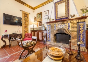  Living room with armchairs and fireplace next to the dining table 