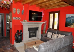  Living room with fireplace in front of the armchairs 