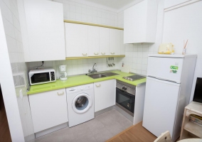 House kitchen with green countertop and washing machine 