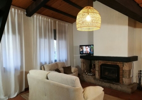  Living room with fireplace in the center and table 