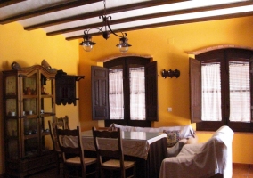  Living room with table and stone fireplace on one side 